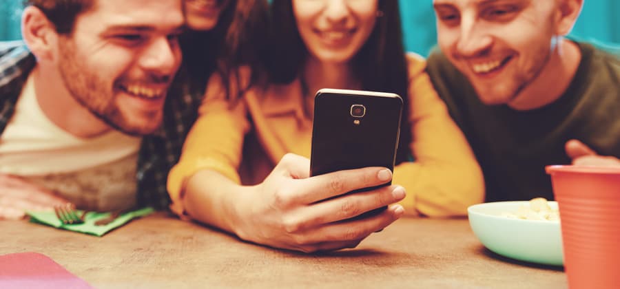 Friends watch a shared video together on a phone