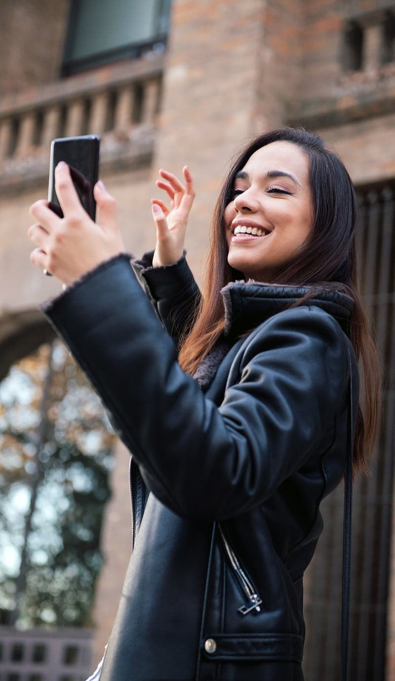 Someone records a selfie response on a phone outdoors